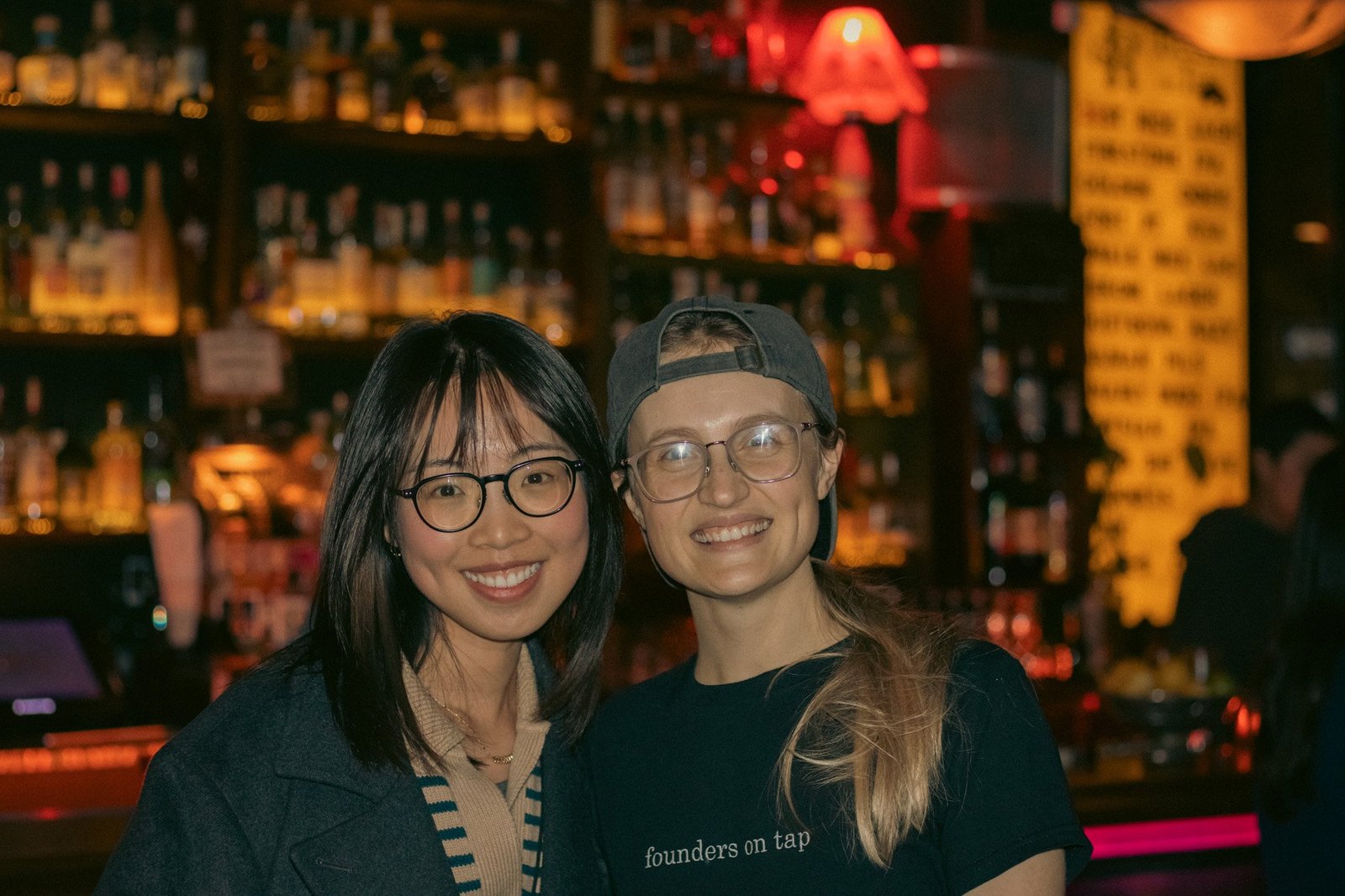 smiles in front of the bottles