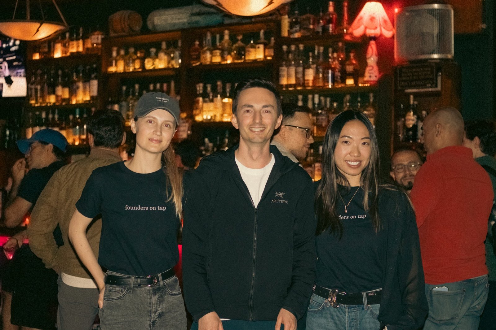 the team with guests at the bar