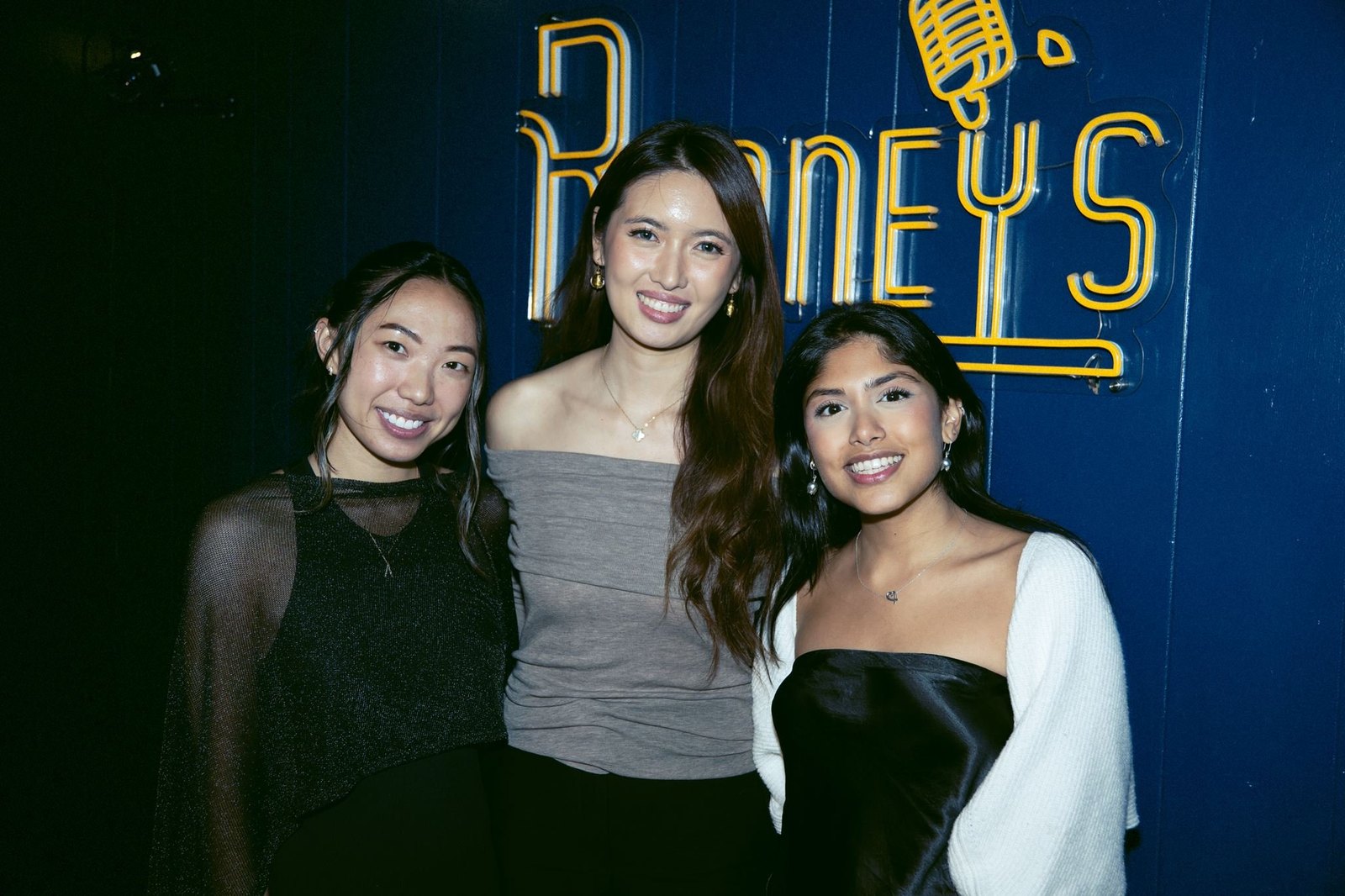three founders under the neon