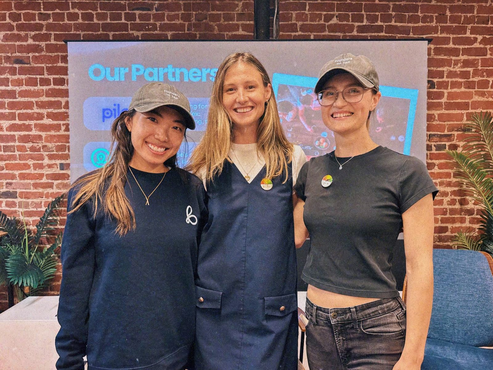 the team in front of the partners wall